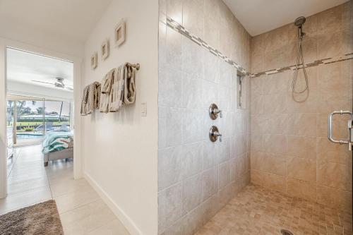 a large bathroom with a shower and a walk in shower at Amazing Water View with heated salt water pool - Villa Riverside - Roelens Vacations in Cape Coral