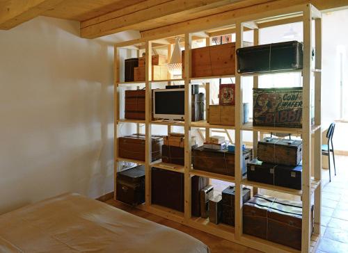 a room with a book shelf filled with boxes at Castello di Granarola Relais - Adults Friendly - in Gradara