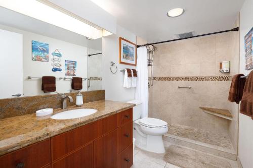a bathroom with a sink and a toilet and a shower at Kona Makai 3-203 in Kailua-Kona