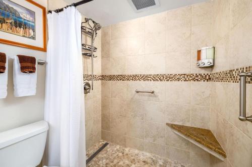 a bathroom with a shower and a toilet at Kona Makai 3-203 in Kailua-Kona