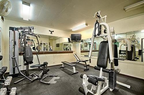 a gym with several tread machines and a mirror at Kona Makai 3-203 in Kailua-Kona