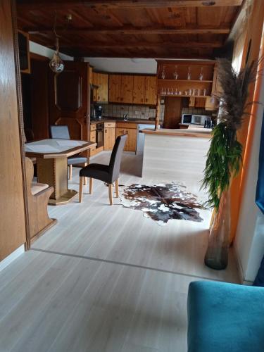 a kitchen and dining room with a table and a chair at Ferienwohnungen Miklautsch in Faak am See