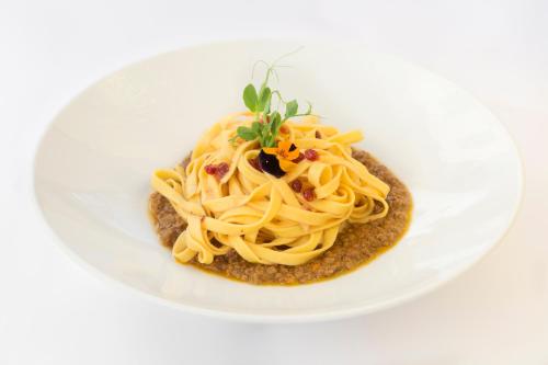 a plate of pasta on a white plate at Historic Hotel Ristorante La Stua in Cavalese