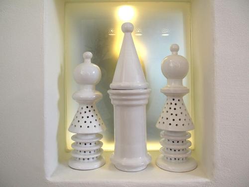 three white vases on a shelf in a room at Castello di Granarola Relais - Adults Friendly - in Gradara
