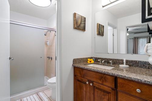 a bathroom with a sink and a shower at Keauhou Surf & Racquet Townhouse #36 in Kailua-Kona