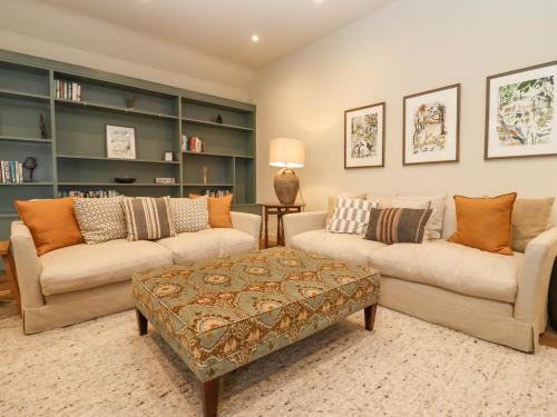 a living room with two couches and a coffee table at Hawthorn Barn in Northleach