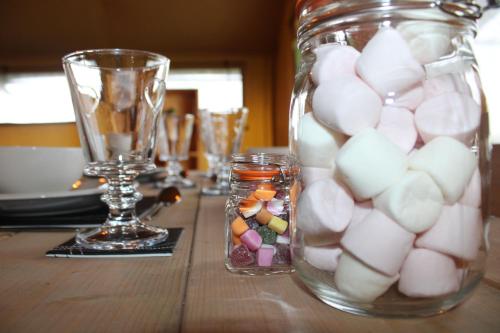a table with a glass jar filled with marshmallows at The Hamlet in Warrington