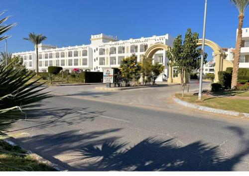 an empty street in front of a large white building at Sharm Hills Resort in Sharm El Sheikh