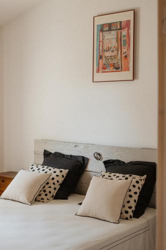- un lit avec des oreillers en noir et blanc dans l'établissement La Garrigue, à Galargues