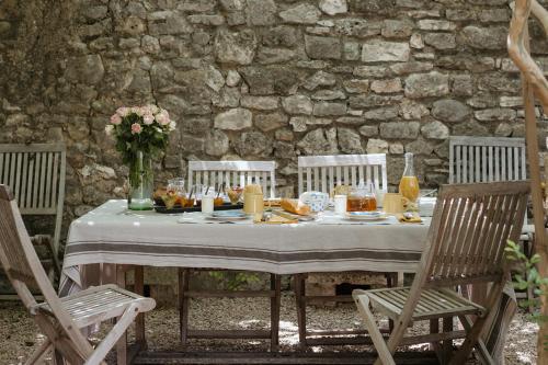 une table avec de la nourriture et des fleurs en haut dans l'établissement La Garrigue, à Galargues