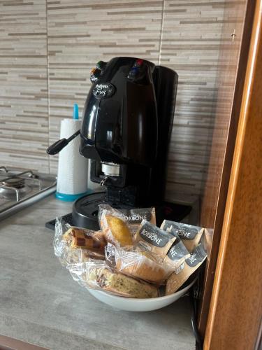 a coffee maker sitting on a counter with a bowl of food at Mya’s Home in Cinisello Balsamo