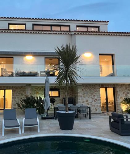 a house with a swimming pool in front of it at La Villa 155 superbe appartement centre ville avec piscine in Mandelieu-la-Napoule