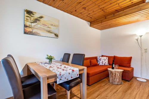 a dining room with a table and a couch at Ferienwohnung Metzgerbauernhof in Wolfach