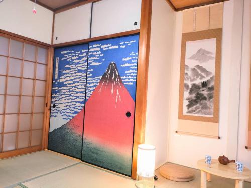 a room with a door with a mountain painted on it at Masaki 1chome house in Nagoya