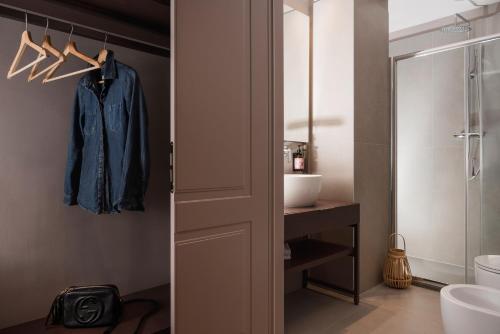 a bathroom with a robe hanging on a door at Garden Suites in Rome
