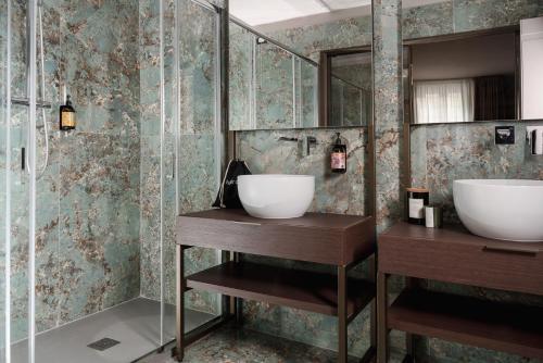 a bathroom with two sinks and a shower at Garden Suites in Rome