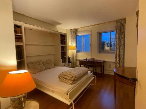 1 dormitorio con cama, escritorio y ventana en Double room in Beautiful apartment, en París