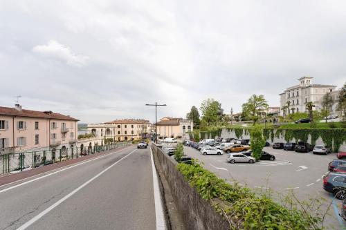 a city street with cars parked in a parking lot at Casa Perry - Lago Maggiore in Borgo Ticino