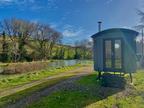 a smallshed sitting on the side of a road at 1 Bed Cabin - Sleeps 2 - HotTub - Parking - Garden in Bideford