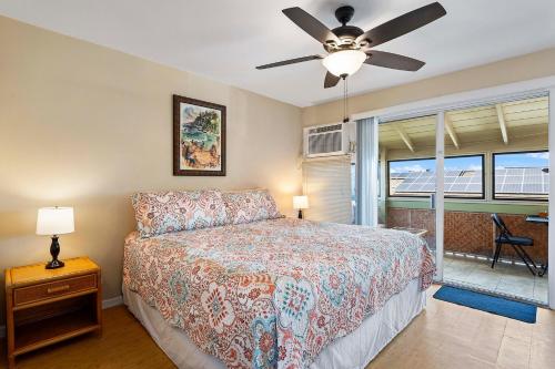 a bedroom with a bed and a ceiling fan at Kona Shores 221 STVR #19-390879 in Kailua-Kona