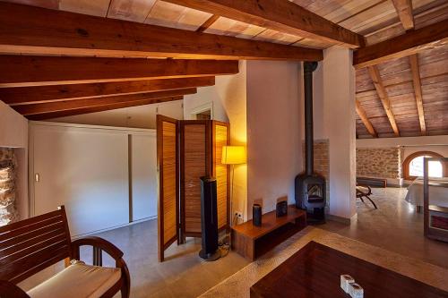 a living room with a wood stove in a room at Ca' n Beia Suites - Adults Only in Alaró