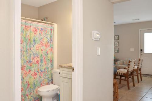 a bathroom with a toilet and a shower curtain at The Palms 2B by Pristine Property Vacation Rentals in Mexico Beach