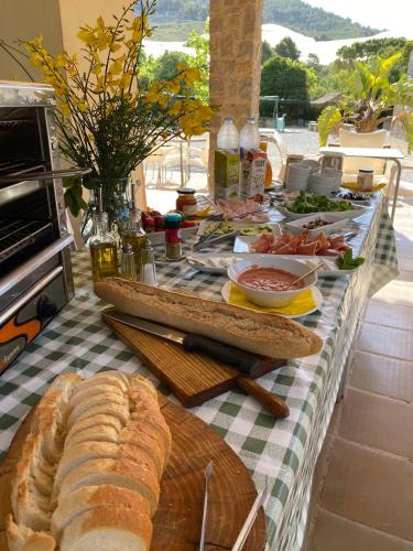 a table with bread and other food on it at Camping Fonts del Algar in Callosa de Ensarriá
