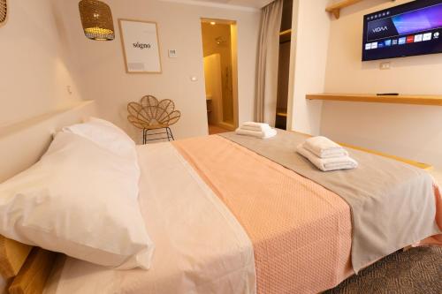 a bedroom with a bed with towels on it at Al Poggiale - Residenza Mediterranea in Porto Cesareo
