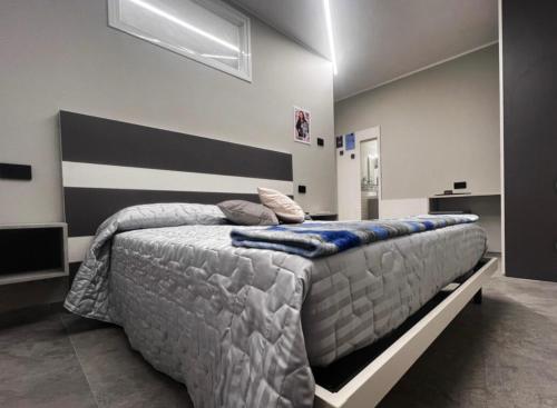 a bedroom with a large bed with blue pillows on it at B&B Borgo Saludecio Rooms in Saludecio