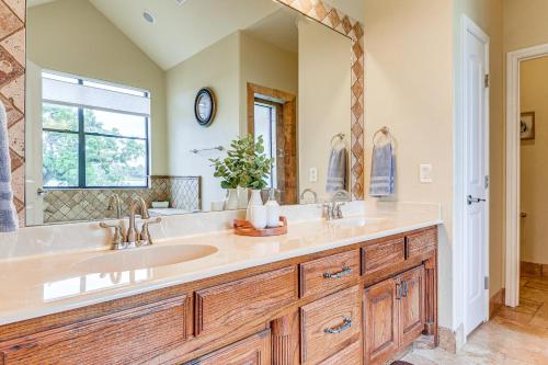 a bathroom with a sink and a large mirror at Family-Friendly Alvarado Lake Home with Kayak, Canoe in Alvarado