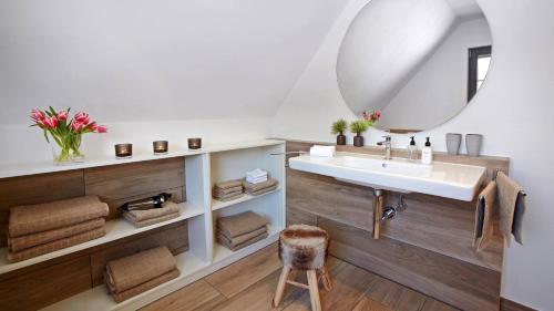 a bathroom with a sink and a mirror at LA MAISON Titisee - Boutique Design Villa im Schwarzwald in Titisee-Neustadt