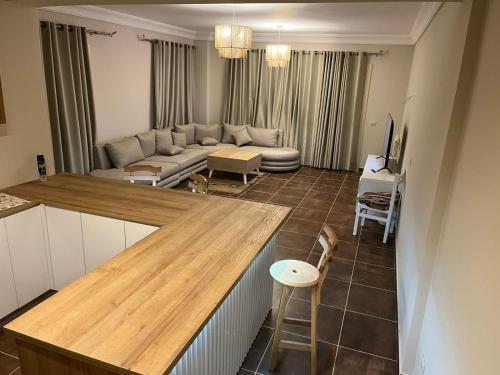 a kitchen and living room with a couch and a table at La vista topaz in Ain Sokhna