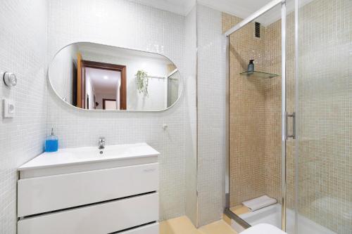 a white bathroom with a sink and a shower at Casa Pepe in Jerez de la Frontera