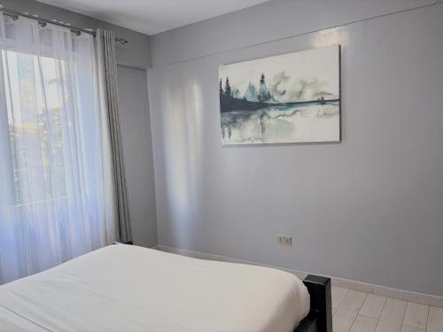 Ένα ή περισσότερα κρεβάτια σε δωμάτιο στο Mideya Gardens