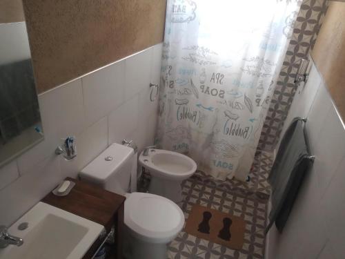 a bathroom with a toilet and a shower curtain at Espectacular Cabaña En Valle Grande Terraza Panorámica 360 in Valle Grande