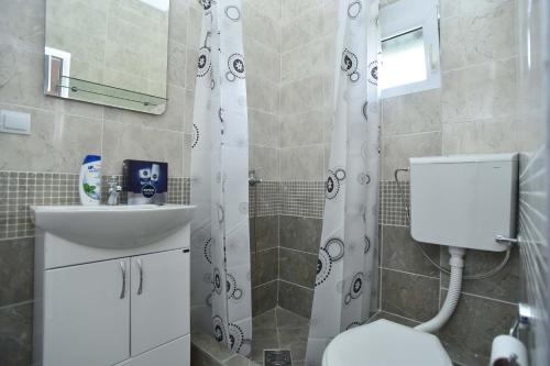 a bathroom with a toilet and a sink and a shower at Apartmani Mihovic - JAZ in Budva