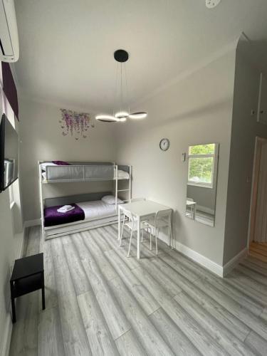 a room with a table and a bed and a desk at Westminster Inn in London