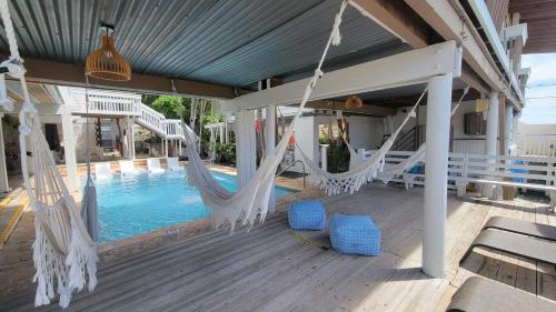 a porch with hammocks and a swimming pool at La Jamaca - An Island Vibe Hotel in La Parguera