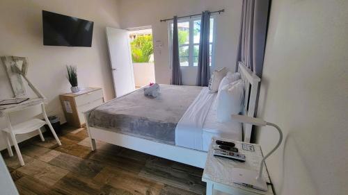 a bedroom with a white bed and a window at La Jamaca - An Island Vibe Hotel in La Parguera