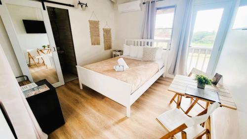 a small room with a bed and a table at La Jamaca - An Island Vibe Hotel in La Parguera