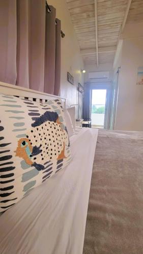 a bedroom with a large bed with a blanket on it at La Jamaca - An Island Vibe Hotel in La Parguera