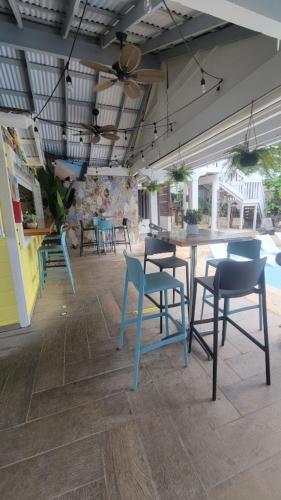 a dining room with blue chairs and a table at La Jamaca - An Island Vibe Hotel in La Parguera