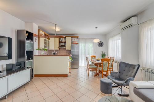 a kitchen and living room with a table and chairs at Apartment Krilo Jesenice in Krilo