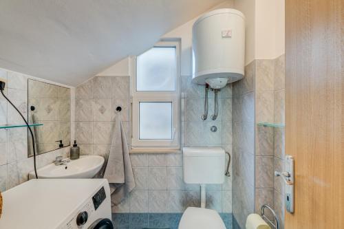 a bathroom with a toilet and a sink at Apartment Krilo Jesenice in Krilo