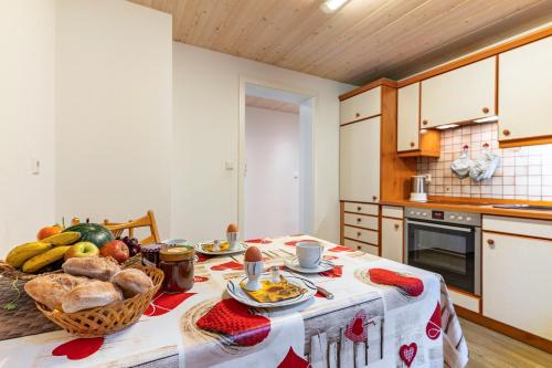 a kitchen with a table with food on it at Ferienwohnung Berghansenhof in Wolfach