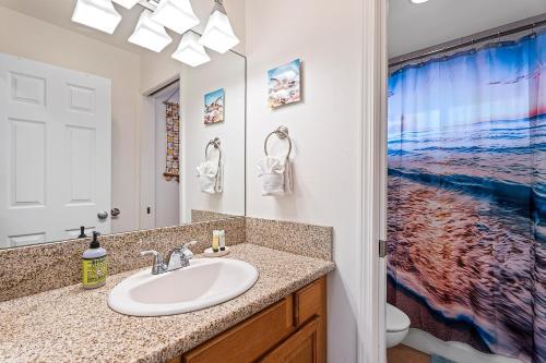 a bathroom with a sink and a mirror at Hale Lio Kai in Kailua-Kona