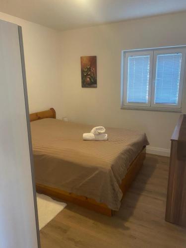 a bedroom with a bed with two towels on it at Apartman Telar in Vodice