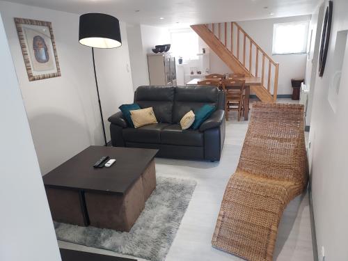 a living room with a couch and a table at Au chant des Grenouilles in Patay