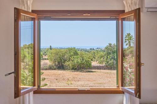 a window with a view of a field at Finca Miralu in Calonge