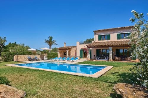 a house with a swimming pool in the yard at Finca Miralu in Calonge